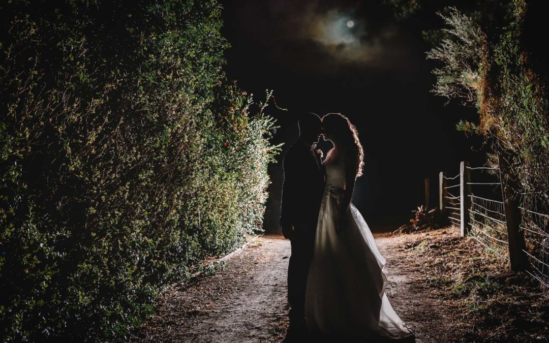 Macarthur wedding photographer - bride and groom stand on a driveway in the moonlight