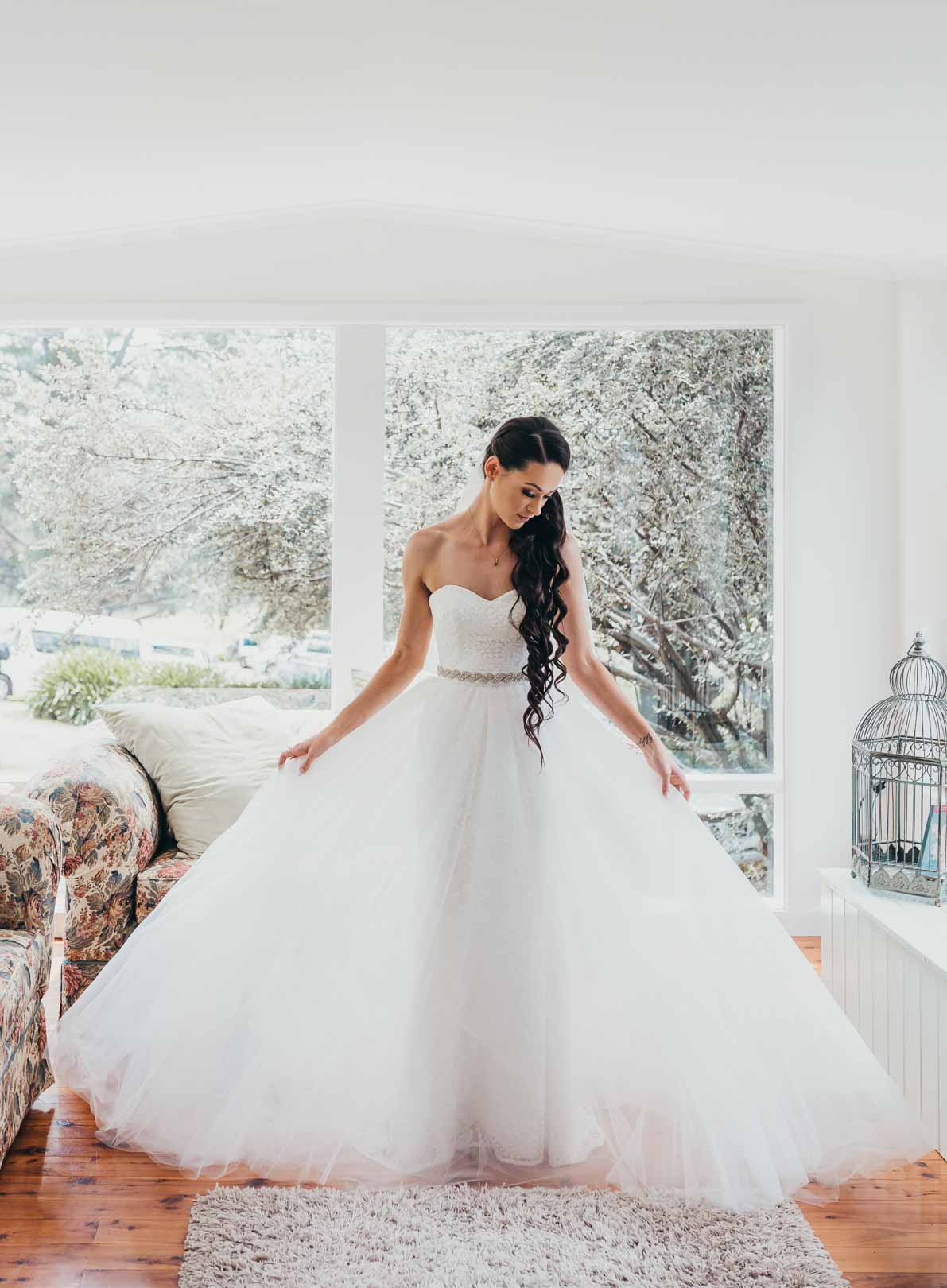 A woman admires her bridal gown before her Chapel Hill wedding