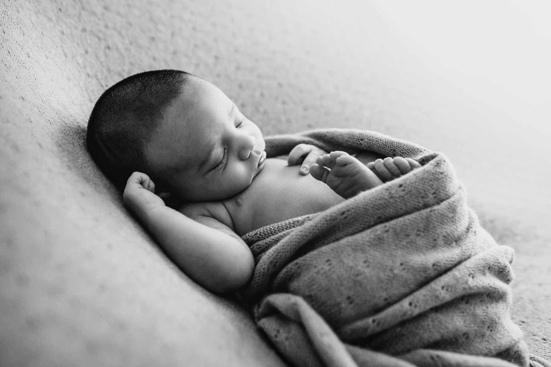 Image of sleeping newborn baby details, little fingers and toes