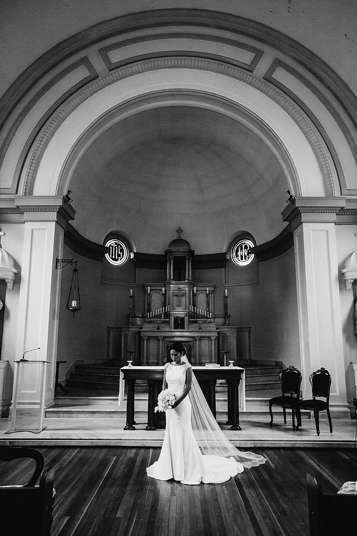 Sydney-Wedding-Photographer-Elysium-Photography-Gledswood-Estate-4 A bride stands in Matre Dei Chapel after their wedding ceremony