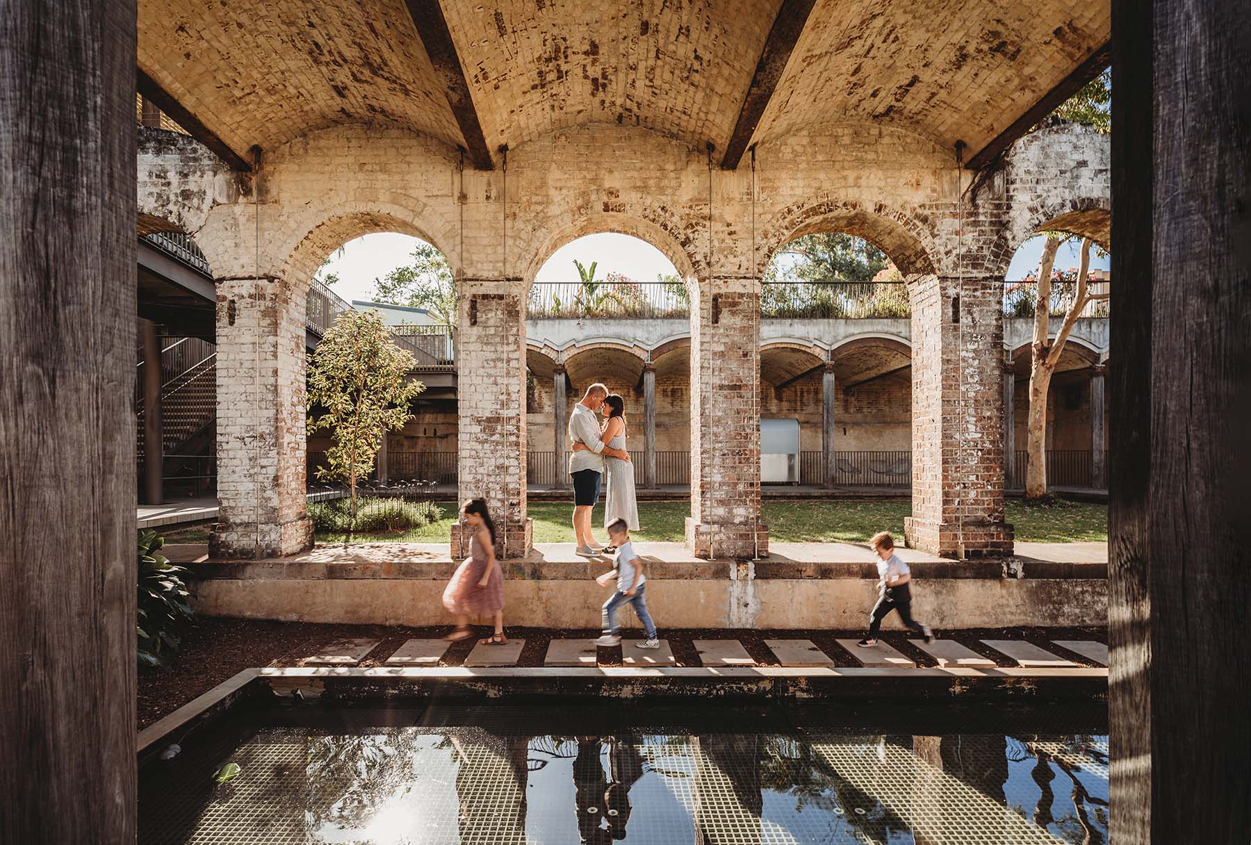 Family Photography - family stand in the arches of Paddington Reservoir Gardens