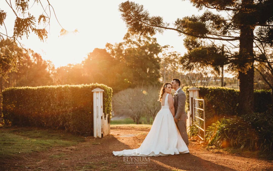 Gledswood wedding - newlyweds stand on a driveway in the golden sunset