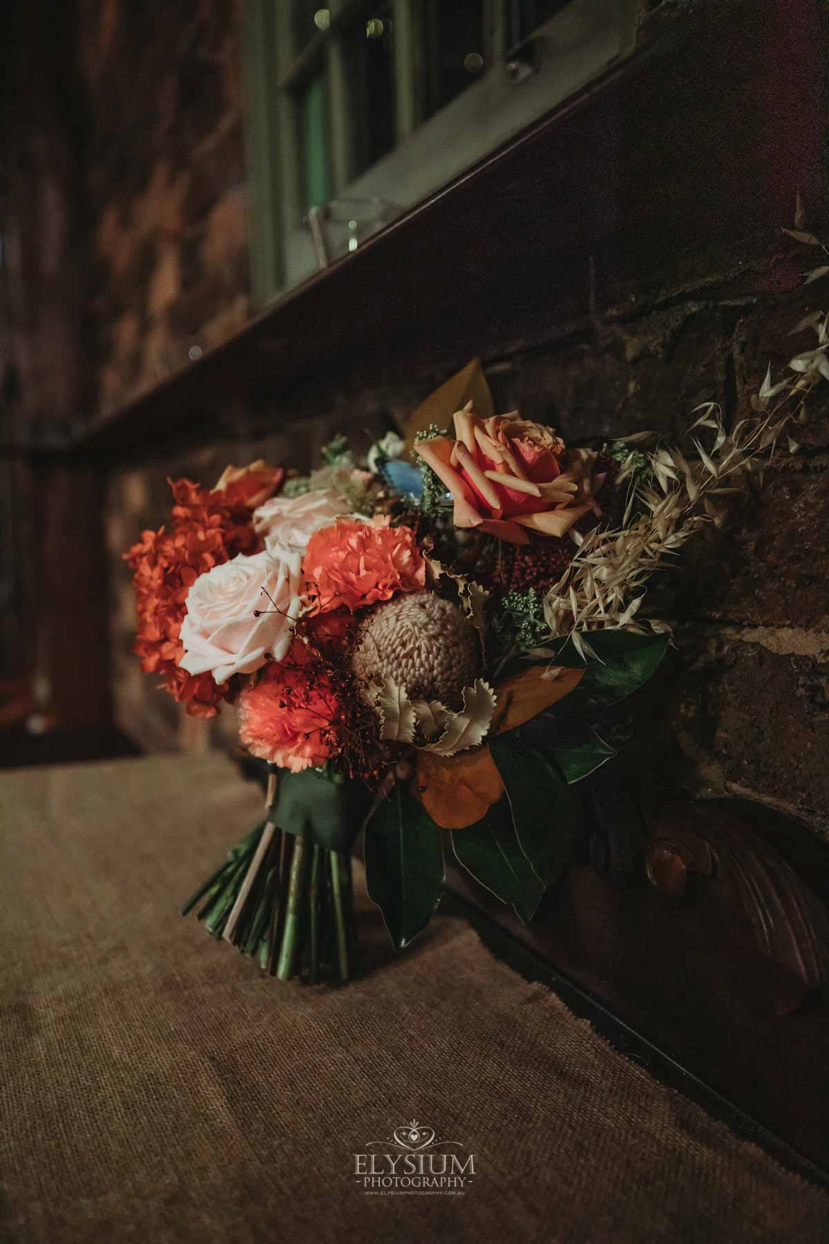 Gledswood Wedding Photo - bridal bouquet sits on a rustic table