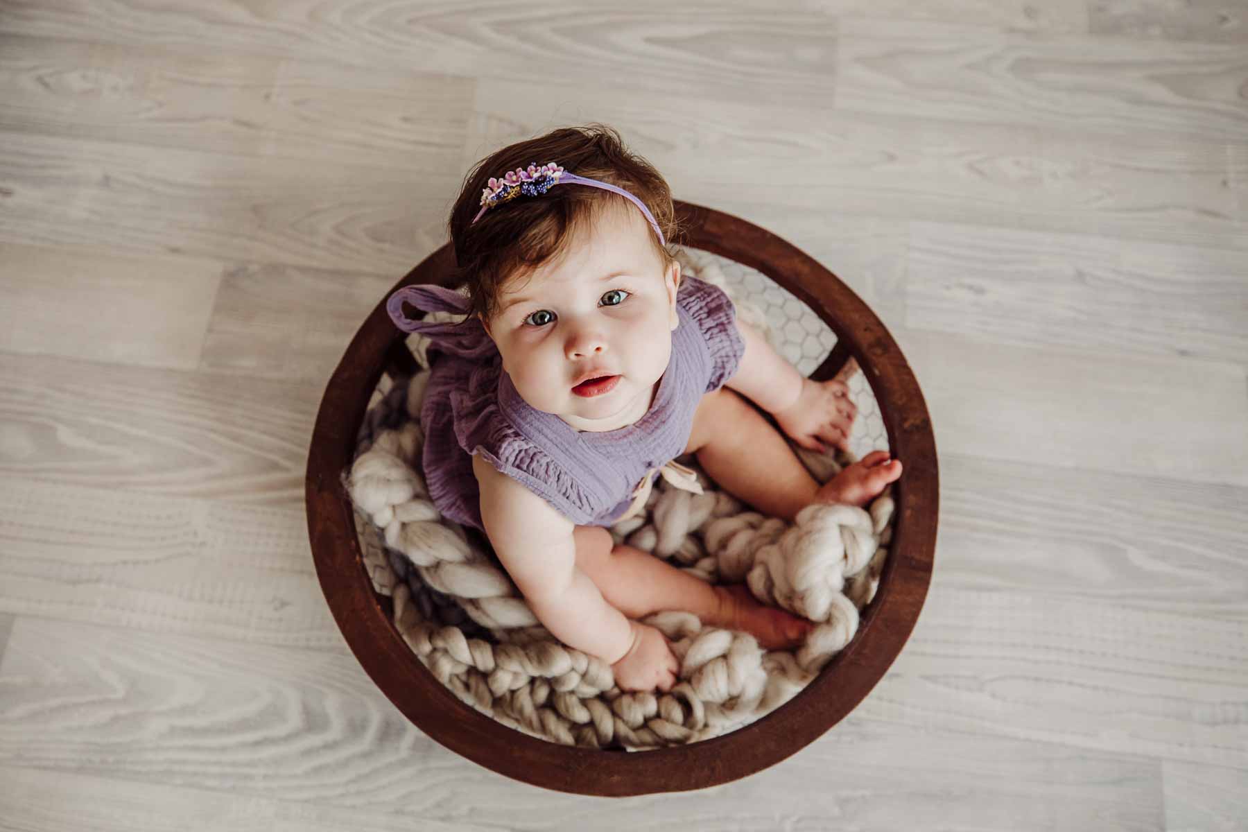 Cake Smash Session - baby girl sits in a round wooden bowl