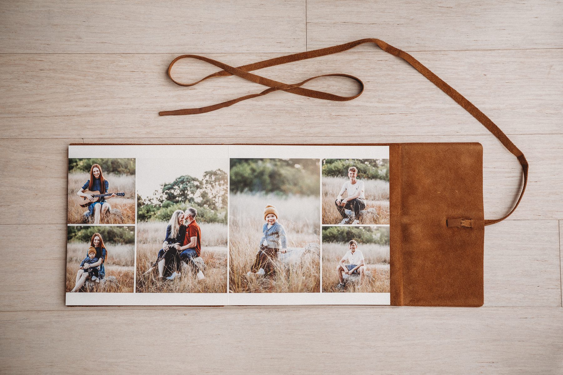 Leather photo album displaying an outdoor family session