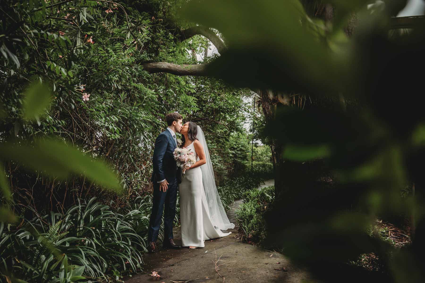 Newlyweds pause for a kiss outside their Springfield House reception