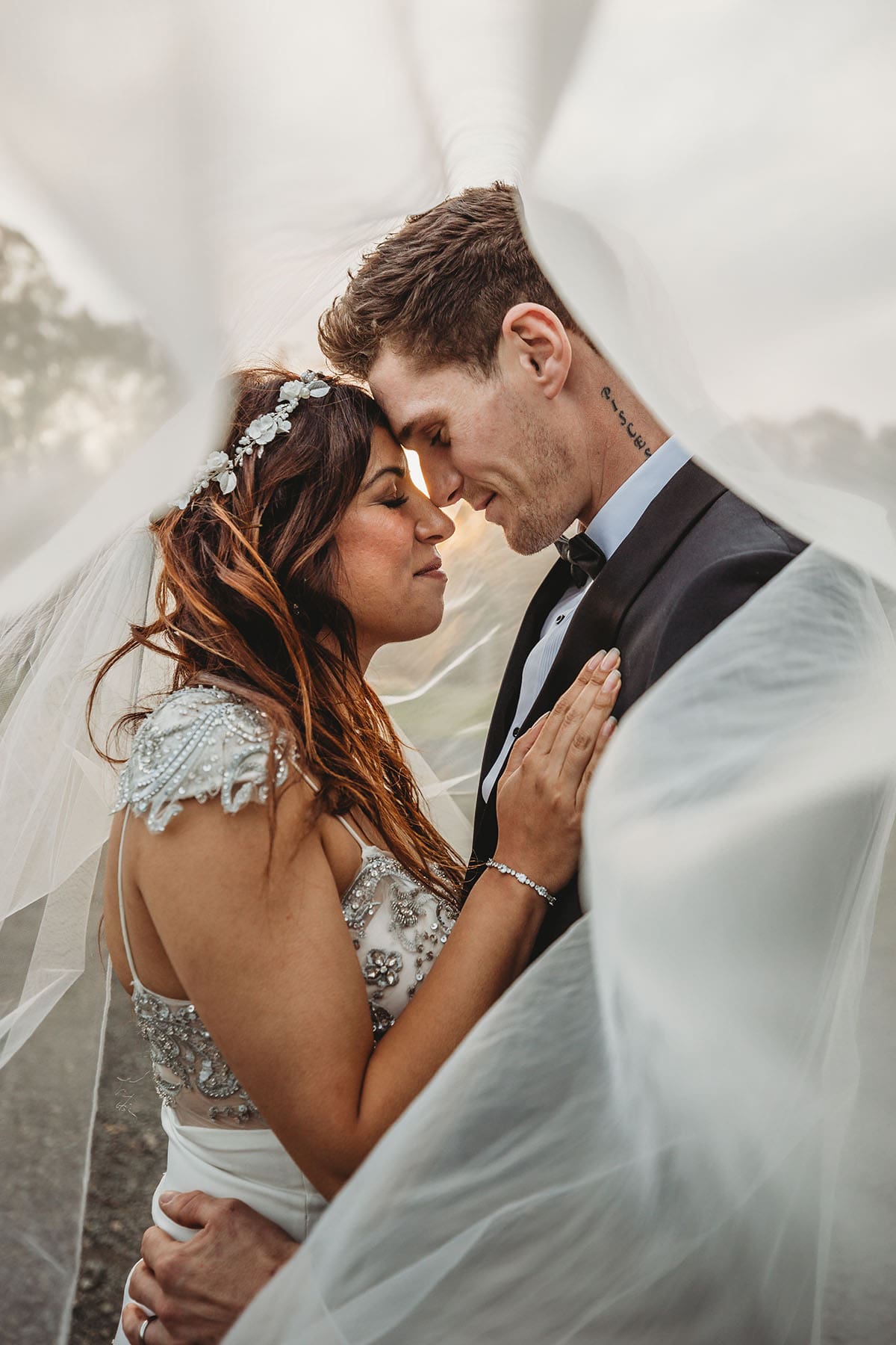 Elysium-Photography-Macarthur-Wedding-Photographer-JI-144 Newlyweds stand with their foreheads together under the brides veil after their wedding