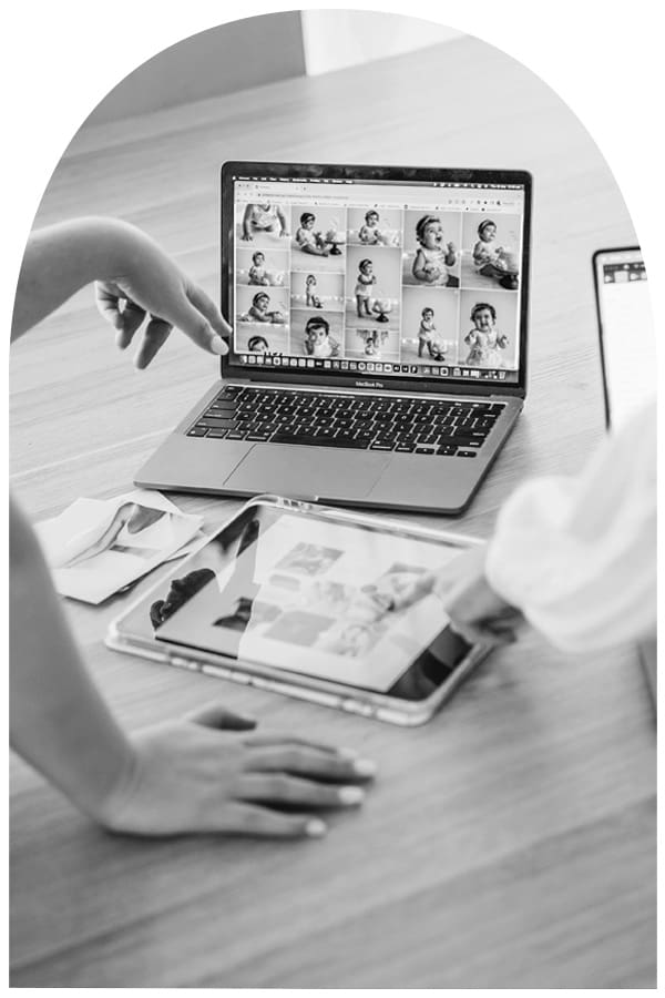 A couple view their image gallery on a laptop screen to select their session photos