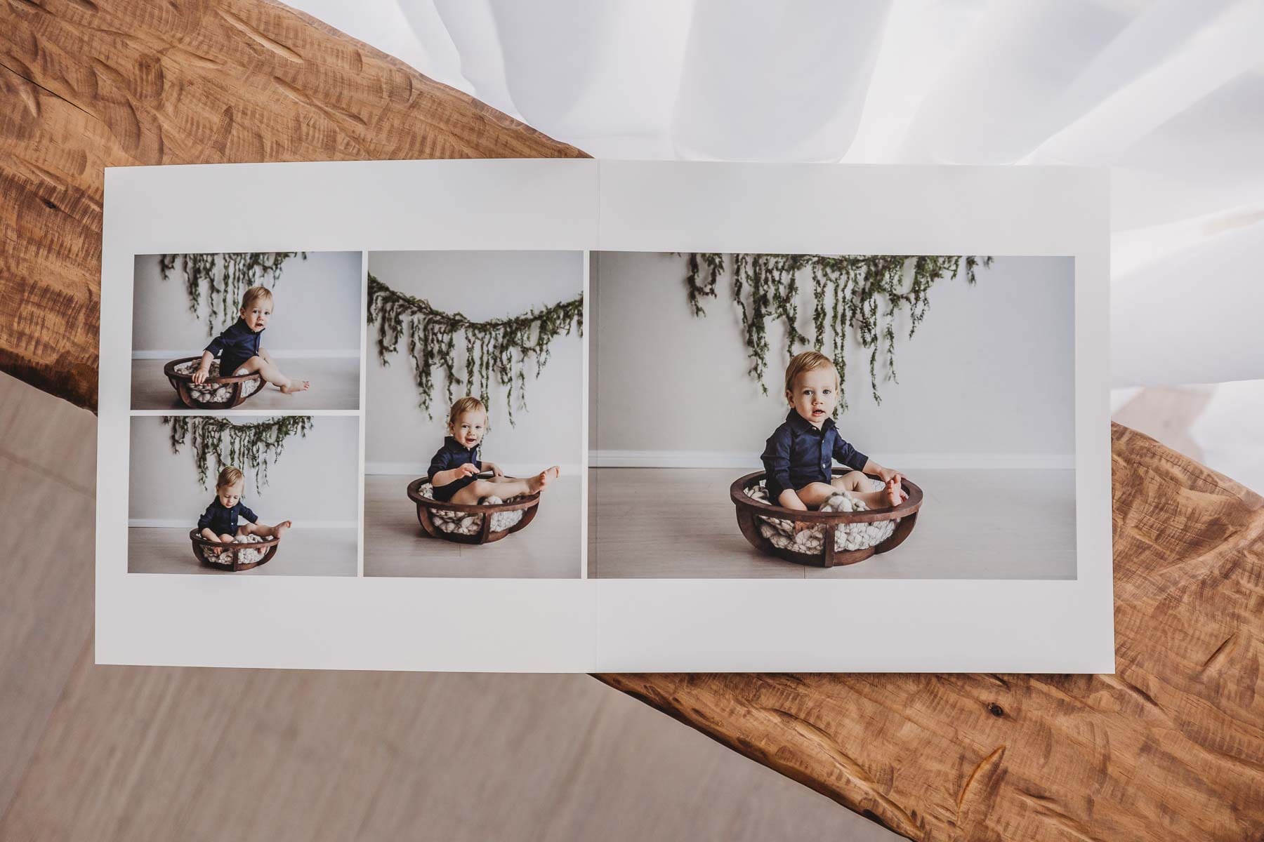 A baby photo album filled with images from a studio baby session