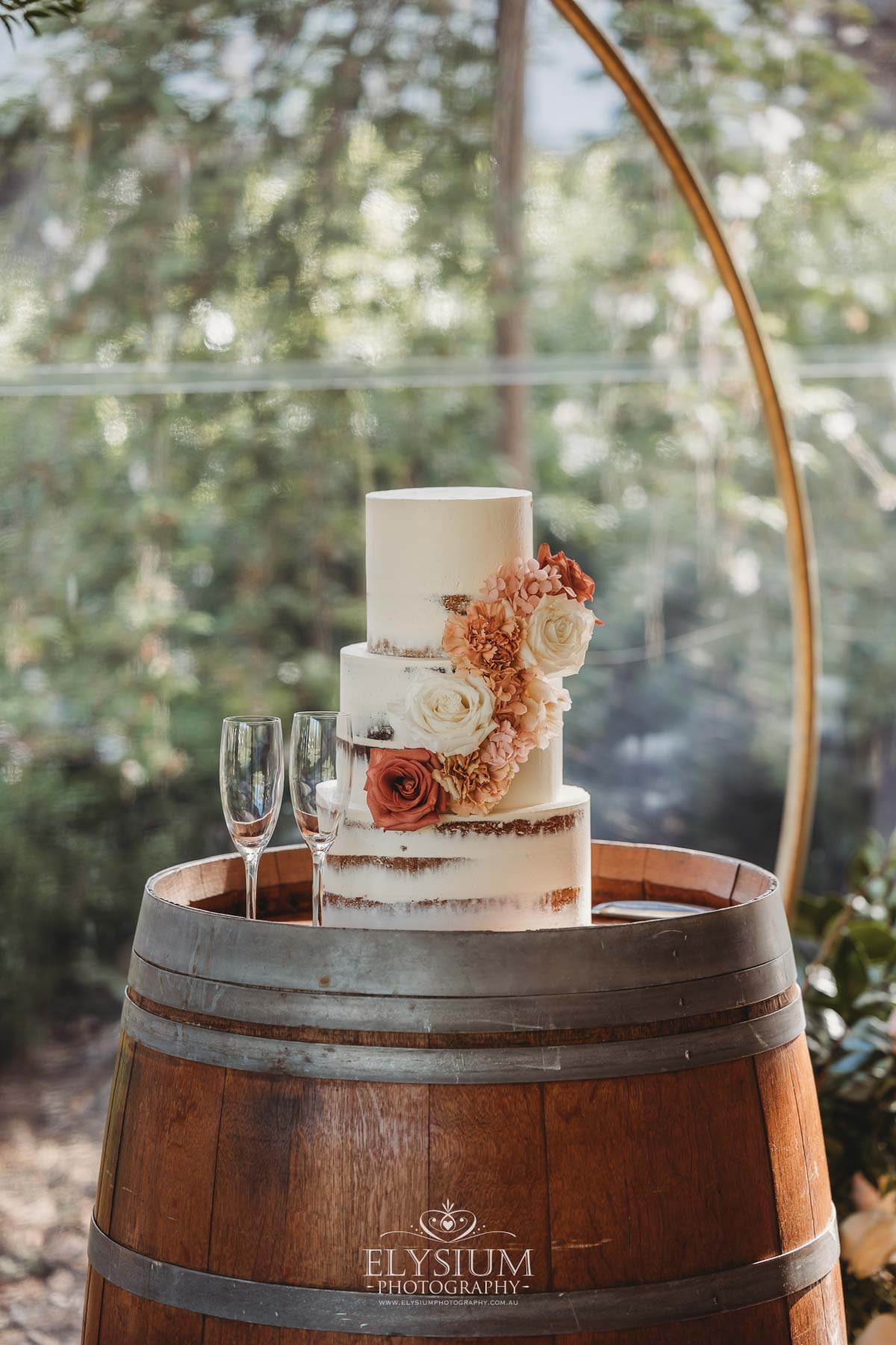 Elysium-Photography-Camden-Wedding-Photographer-SP-327 Cake floral details set up for the wedding reception with peach coloured accents at Burnham Grove