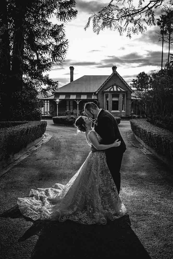 Gledswood Wedding Photo - bride and groom stand under the arch during the ceremony