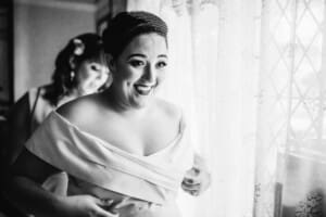 Sydney Wedding Photographer - brides mother helps with her gown