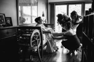 Sydney Wedding Photographer - bridal party help the bride with her shoes