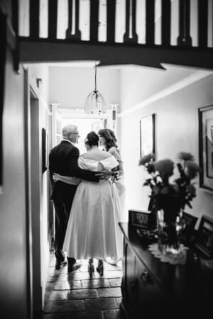 Sydney Wedding Photographer - bride hugs her parents as they leave for the ceremony