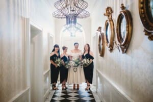 Sydney Wedding Photographer - bridal party stand in a long hallway