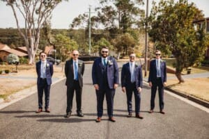 Sydney Wedding Photographer - groom and groomsmen stand in the street