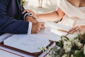 Sydney Wedding Photographer - groom signs the marriage certificate