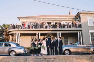 Sydney Wedding Photographer - bridal party stand outside the reception venue