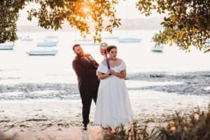 Sydney Wedding Photographer - bride and groom have a mock battle