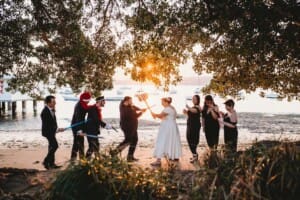 Sydney Wedding Photographer - bridal party have a mock battle