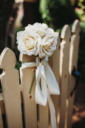 Sydney Wedding Photographer - flowers attached to the brides garden fence