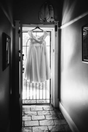 Sydney Wedding Photographer - bridal gown hanging in a doorway