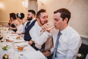 Sydney Wedding Photographer - groomsmen make a toast at the reception