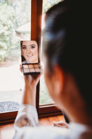 Sydney Wedding Photographer - bride looks at her make-up in a mirror