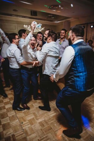 Sydney Wedding Photographer - groomsman catches the brides garter