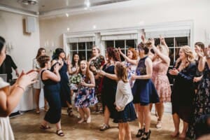 Sydney Wedding Photographer - a guest catches the brides bouquet