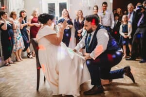 Sydney Wedding Photographer - groom removes the brides garter