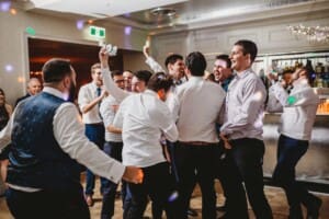 Sydney Wedding Photographer - groomsman catches the brides garter