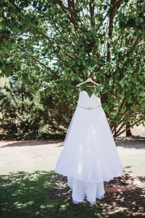 Gledswood Wedding - bridal gown hanging from a tree