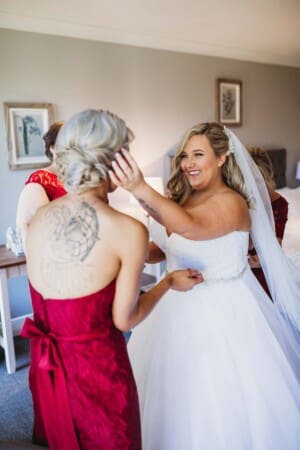 Gledswood Wedding - bride smiles at her bridesmaid before the ceremony