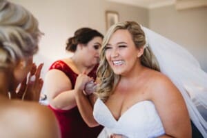 Gledswood Wedding - bride laughs with her bridesmaid before the ceremony