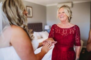 Gledswood Wedding - bride exchanges gifts with her bridesmaid