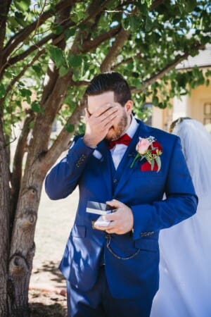 Gledswood Wedding - groom cries as he opens a gift from his bride