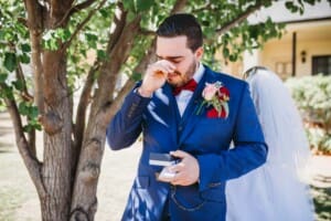 Gledswood Wedding - groom cries as he opens a gift from his bride
