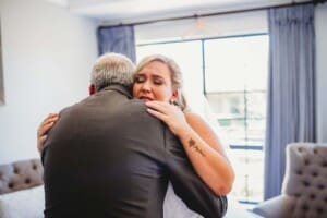 Gledswood Wedding - brides father hugs his daughter and cries