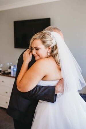 Gledswood Wedding - bride hugs her father as he gets emotional
