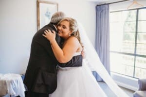 Gledswood Wedding - brides father hugs his daughter