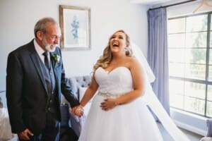 Gledswood Wedding - bride laughs with her father before the ceremony