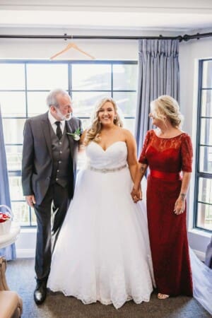 Gledswood Wedding - bride stands with her parents before the ceremony