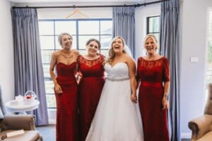 Gledswood Wedding - bride laughs with her bridesmaids before the ceremony