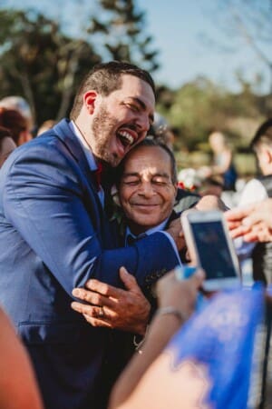Gledswood Wedding - groom hugs his dad after the ceremony