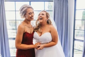 Gledswood Wedding - bride laughs with her bridesmaid