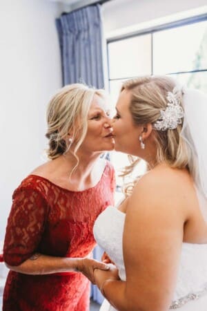 Gledswood Wedding - bride kisses her mum during bride prep