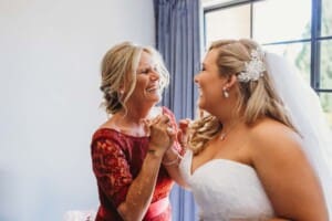 Gledswood Wedding - bride laughs with her mum during bride prep