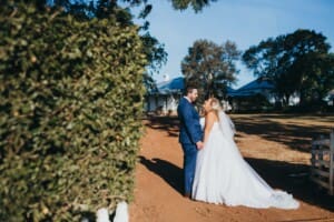 Gledswood Wedding - bride and groom hold hands in the driveway