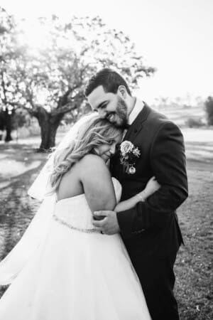 Gledswood Wedding - bride and groom cuddle at sunset